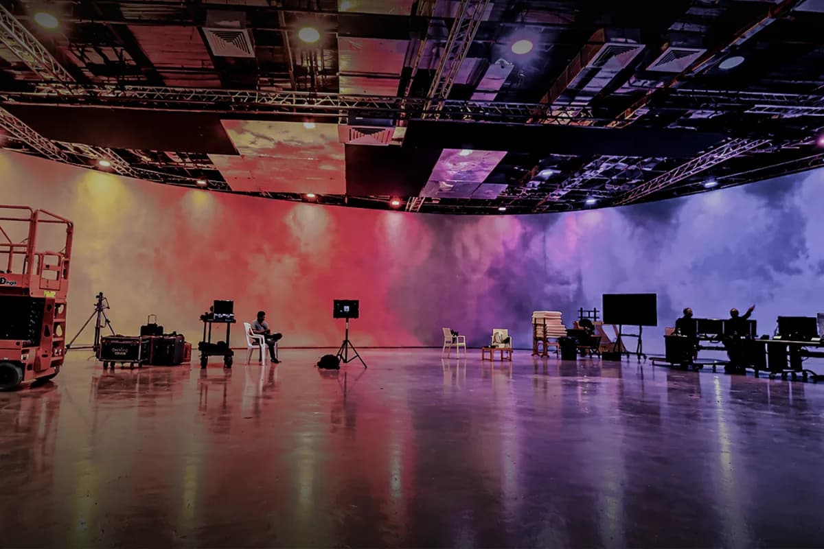 Wide view of the LED volume with crew and equipment on the stage floor